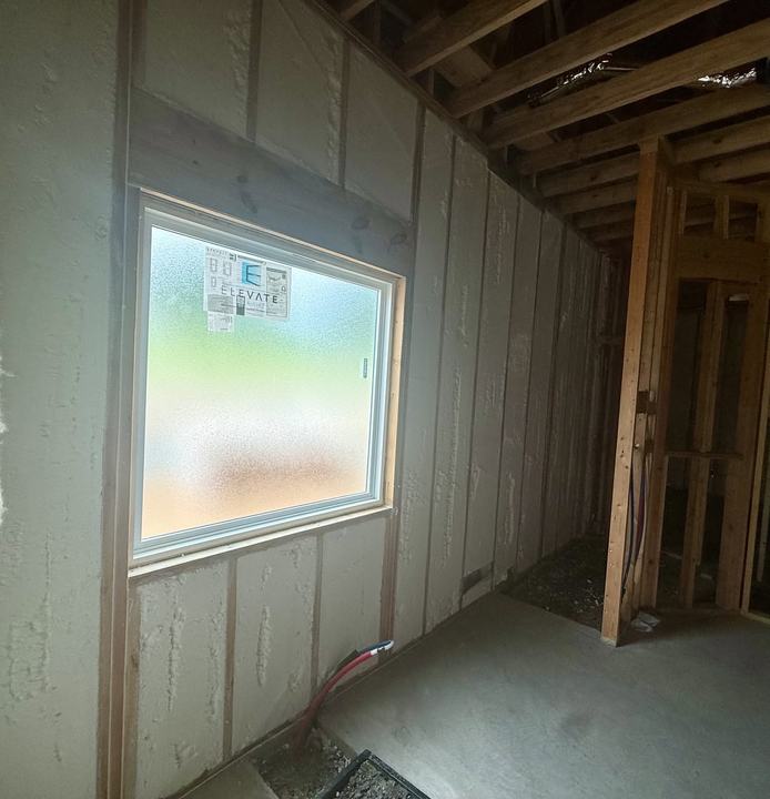 Spray foam insulated wall with window in a new construction home
